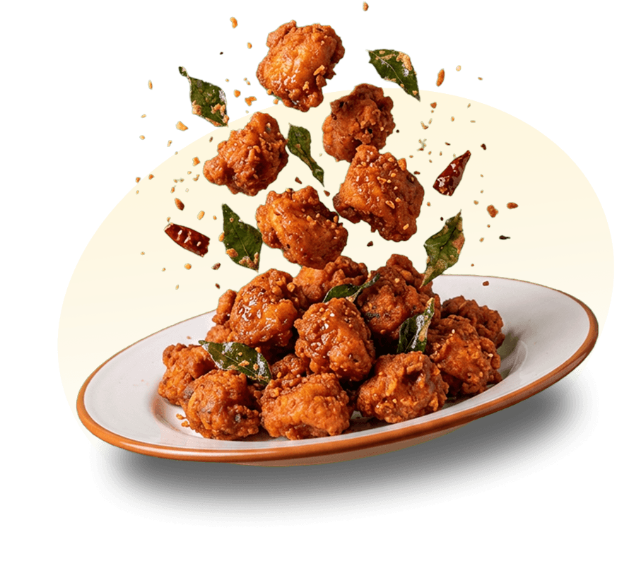 Crispy Saivai pieces tossed over a plate with curry leaves and chillies