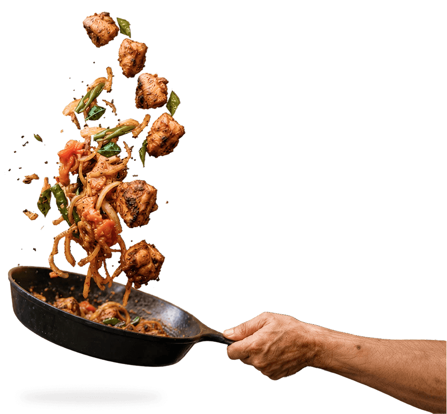 Saivai pieces being tossed in a pan with onions and peppers